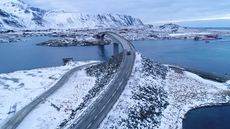 a van drives across a bridge on the wintry lofoten islands norway