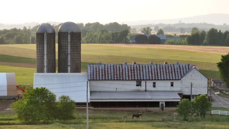 Aerial-cinematic-shot-of-a-farm-and-warehouse-in-Lancaster-County,-Philadelphia,-Pennsylvania