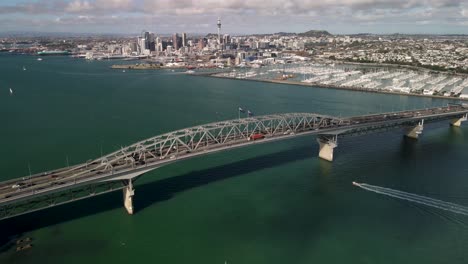 Birds-eye-view-of-New-Zealand-biggest-metropolitan-city,-fly-over-Harbour-Bridge,-Auckland-CBD-cityscape