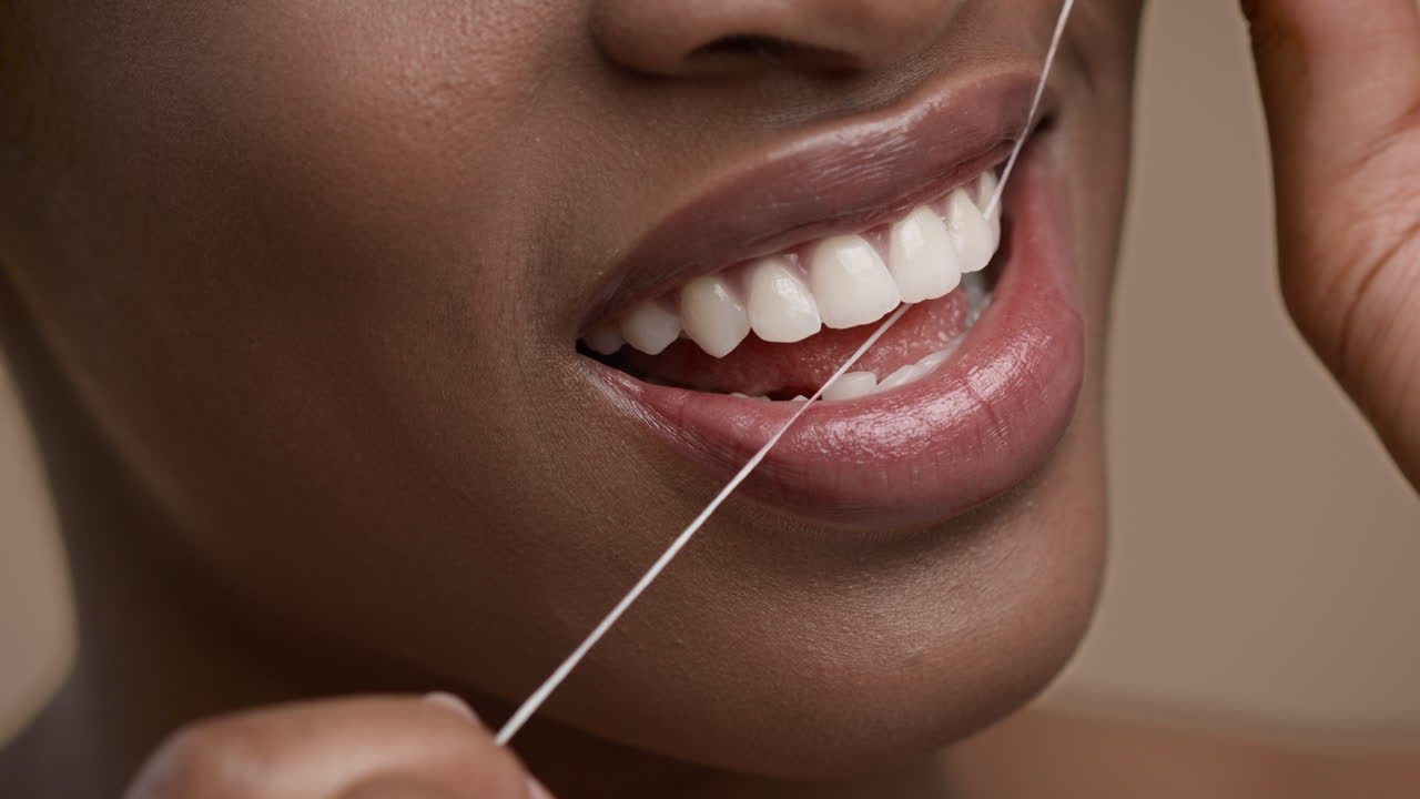 Woman Flossing Her Teeth