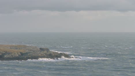 rough sea with waves crashing into rocks