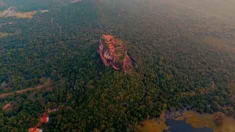 cinematic aerial drone clip flying over the majestic sigiriya rock at sunrise in central sri lanka.