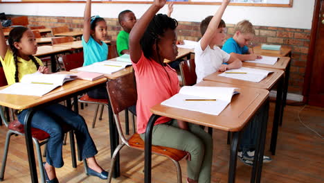 pupils raising their hands during class