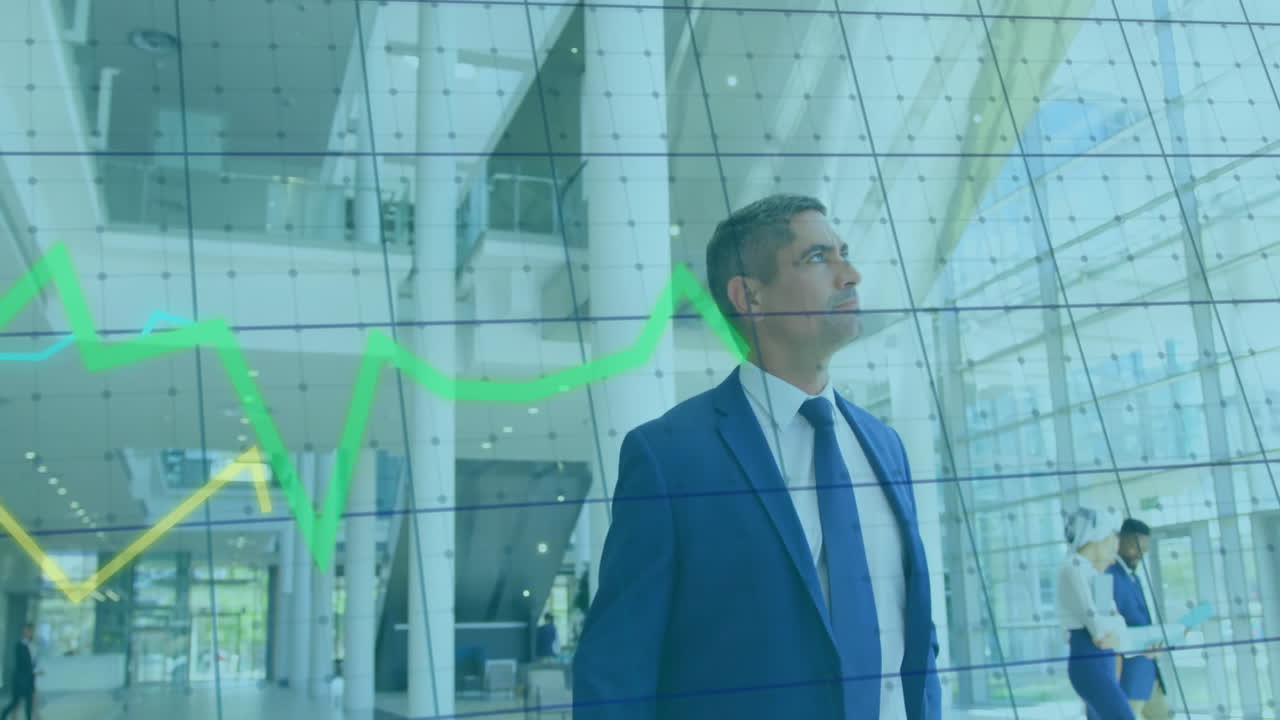 Observing financial graph animation, businessman in suit in modern office building