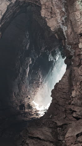 a dark cave entrance with light shining through