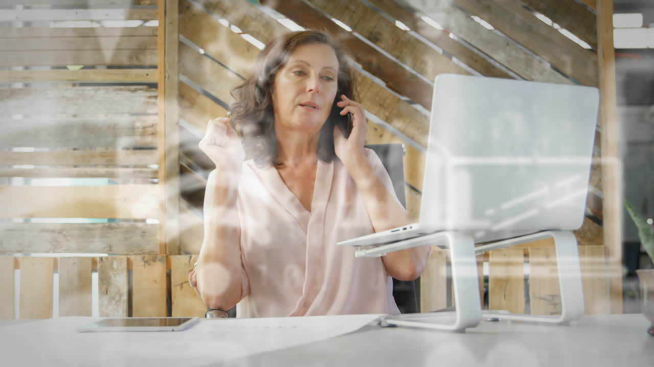 Animation of digital icons over businesswoman using smartphone