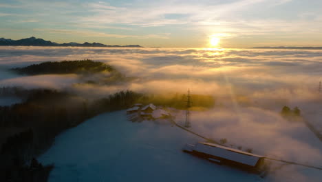 beautiful sunset above the winter fog near savigny village in vaud, switzerland