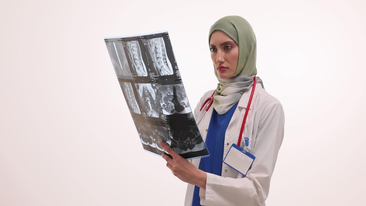 Female Doctor in Hijab Examining Medical Scans