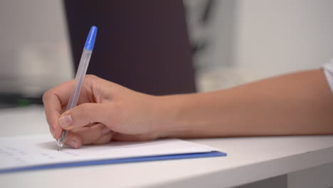 Close-Up-Of-The-Hand-Of-A-Female-Doctor-Writing-The-Symptoms-And-Prescription-Of-A-Patient-In-Her-Office