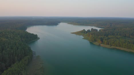 Aerial-reveal-of-reflective-lake