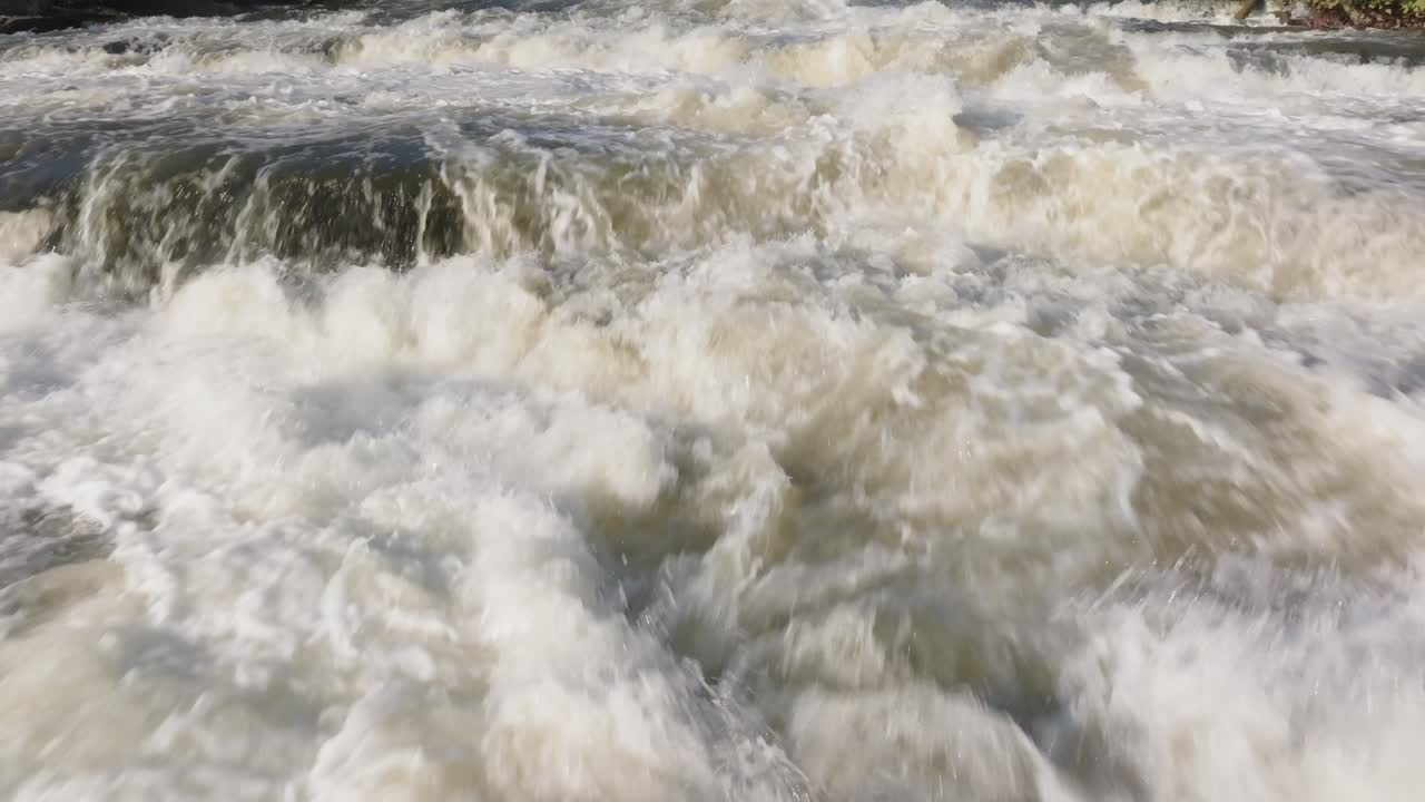 Raging waterfall in Owen Sound, Canada with powerful cascading water in daylight