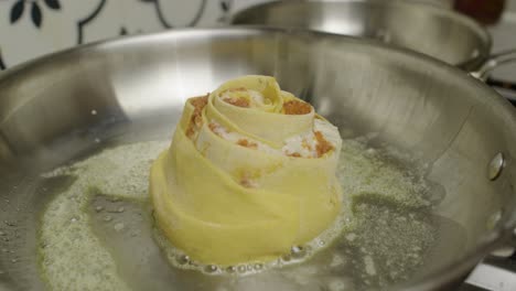 lasagna roll fried in hot frying pan with melted butter