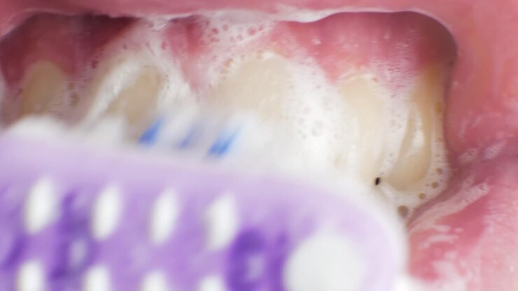 brushing the teeth of a male adult CLOSE UP