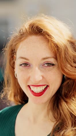 close-up portrait of a smiling redhead woman with freckles