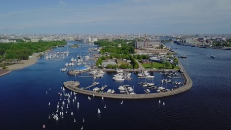 yachts port in a city bay, summer sun, white ripples on a water