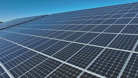 close up drone shot of solar panel units on rooftop of industrial building