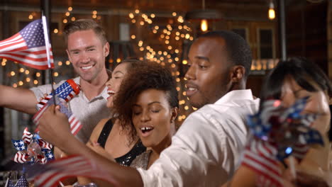 friends celebrating july 4th at a party in a bar