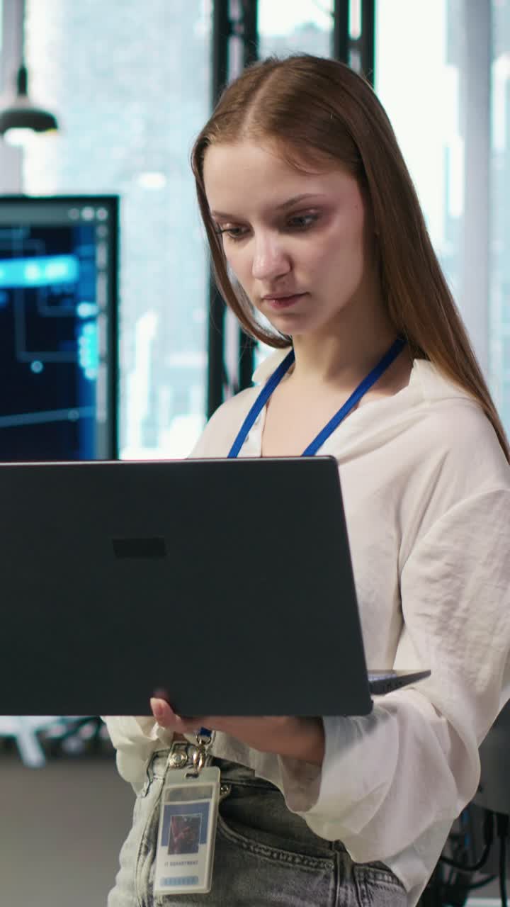 Vertical video Portrait of smiling female engineer coding with AI language model