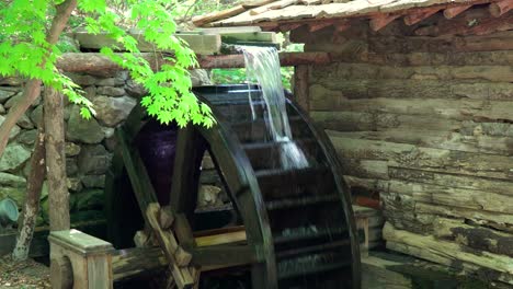 water flow on water wheel as a part of korean traditional watermill in a zen garden at a korean folk village in yongin, south korea