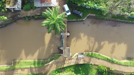 aerial view of a canal bridge in a rural village