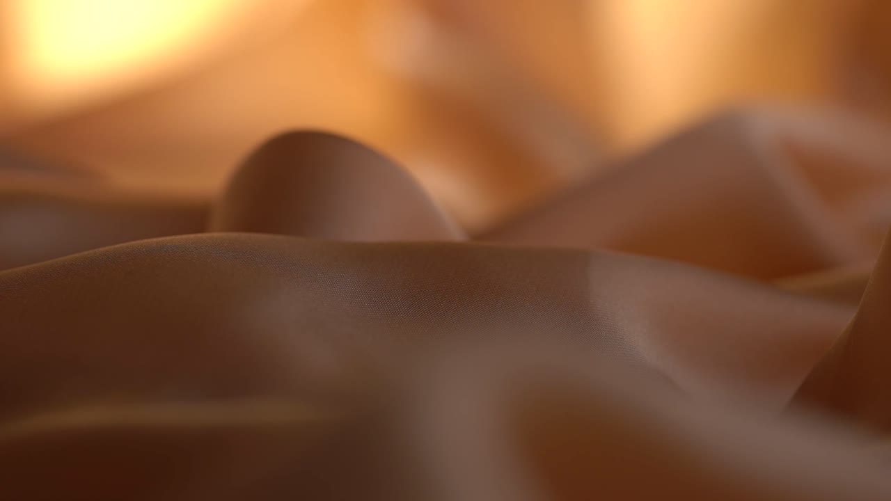 Close Up Shot Of Silk Textiles Used In The Fashion Industry Backlit By Studio Lighting.