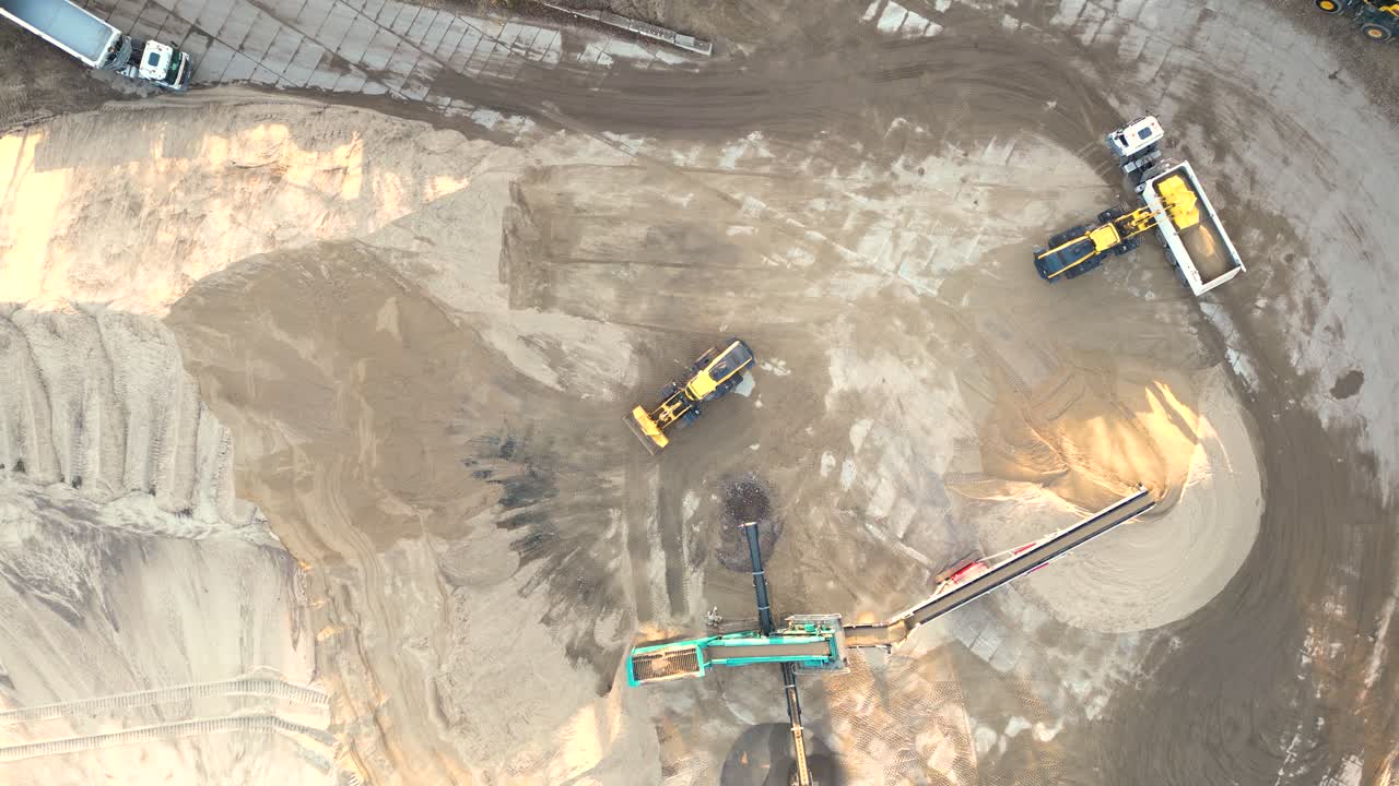 Mining truck transporting sand at sand quarry aerial view of mining machinery moving at sand mine top view of mining equipment at sand mine mining industry heavy vehicle at sandpit
