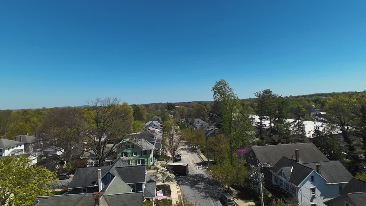 American neighborhood with main street during sunny day in spring