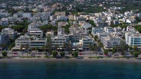 Aerial-drone-video-of-tourist-coastline-with-apartments-next-to-the-sea-on-Kos,-Greece