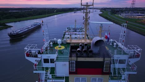 the navigation radars and stern of container ship operating in calm water