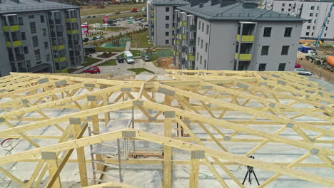 wooden timber framework rooftop under construction close up with low aerial drone shot angle