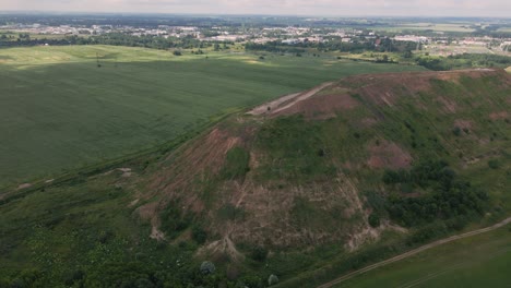 household waste landfill. closed for processing. environment protection. close-up shot. the city is visible on the horizon. close-up shot. aerial photography.