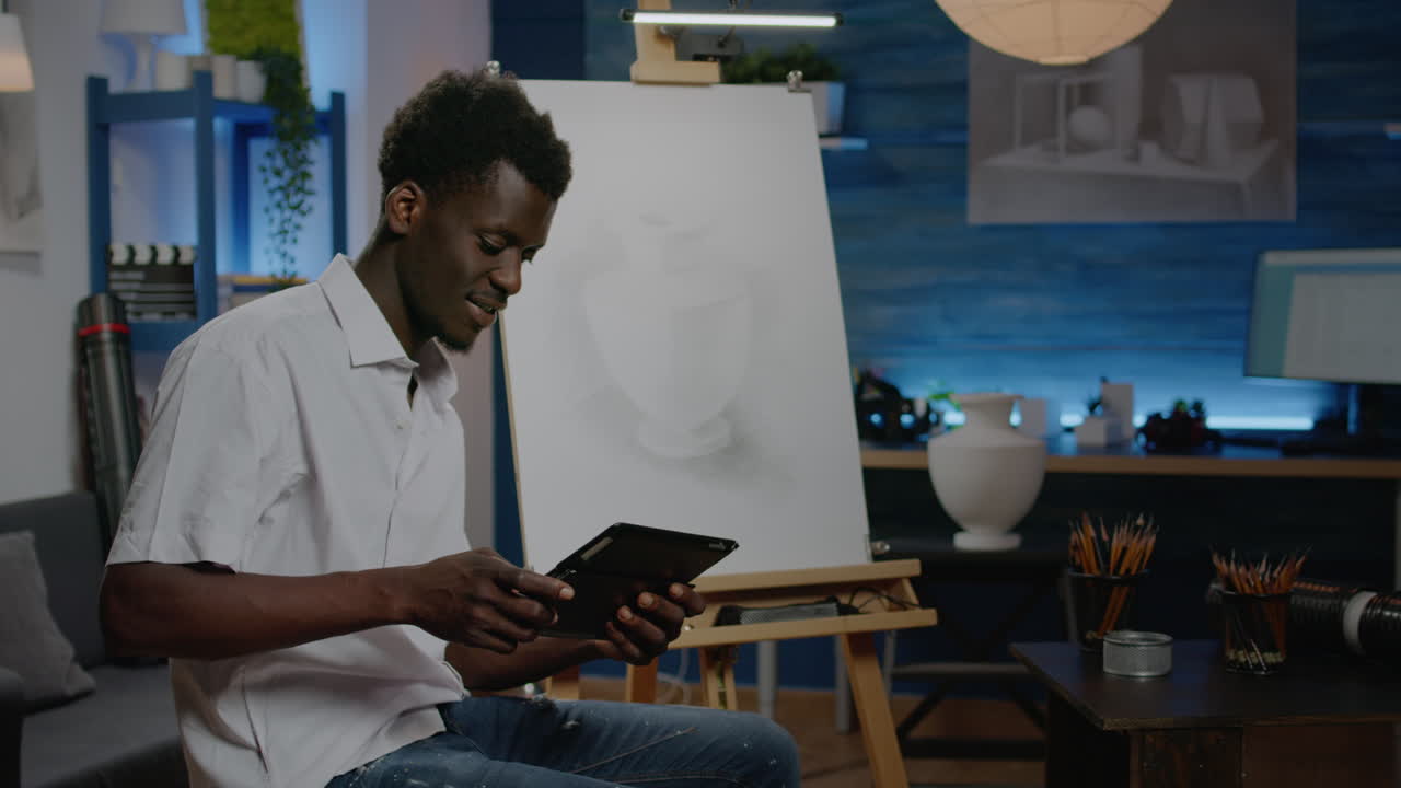 African american creative artist using digital tablet