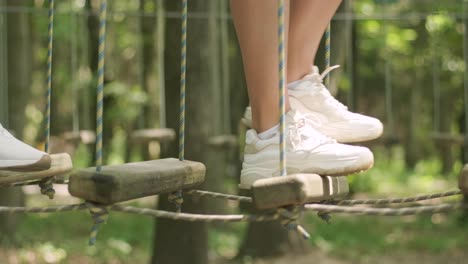 adventure climbing high wire park - people on course in mountain helmet and safety equipment