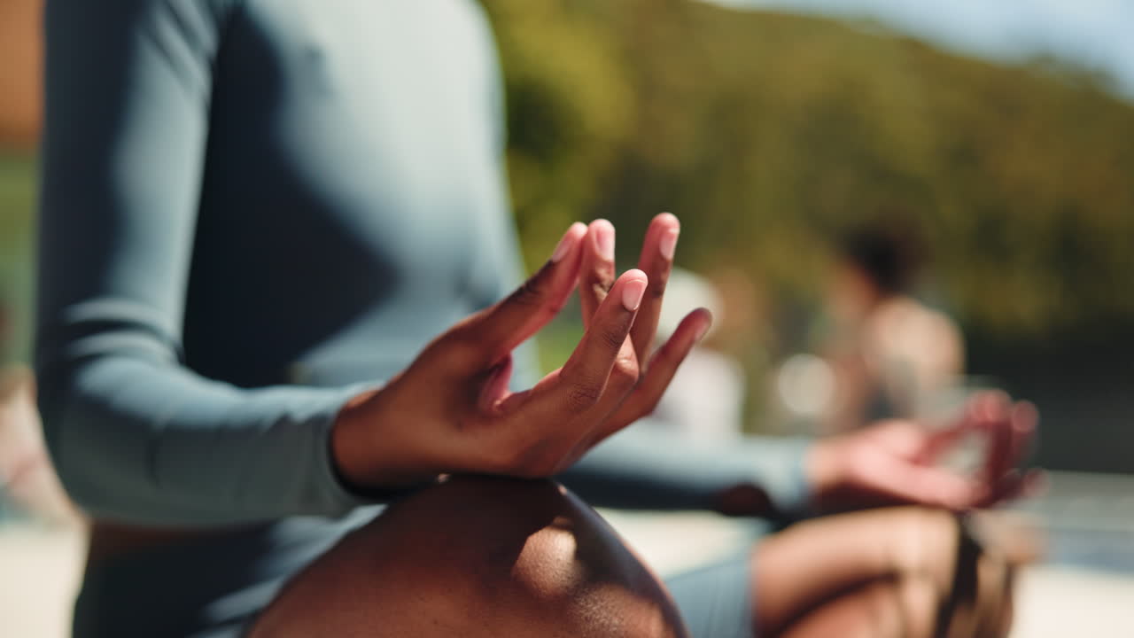 Woman meditating in lotus position outdoors
