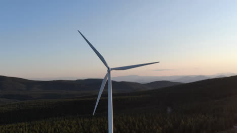 giant windmill generating clean energy in mountain terrain