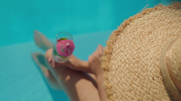 Woman Relaxing in a Pool with a Cocktail