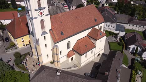 bird's eye view drone flies by a church in austria - steinakirchen am forst