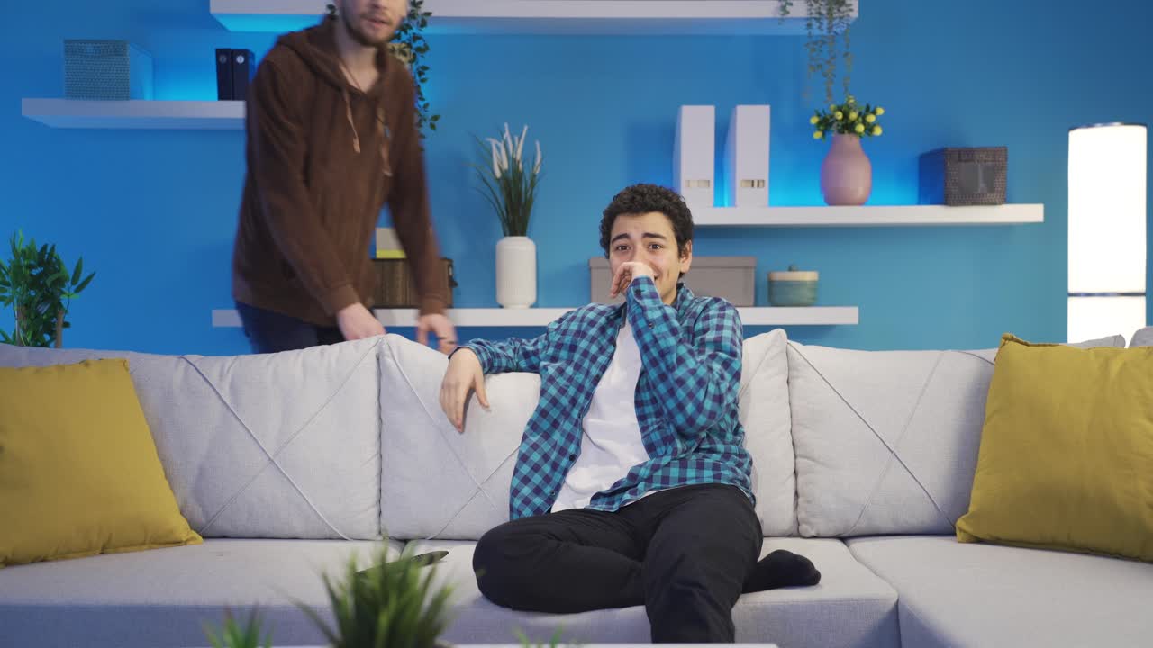 Brother makes his little brother horny watching TV at home. Sibling conflict.