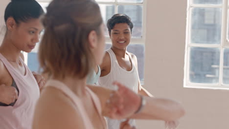 yoga class group of multiracial women chatting having conversation enjoying sharing lifestyle ready for workout in fitness studio at sunrise