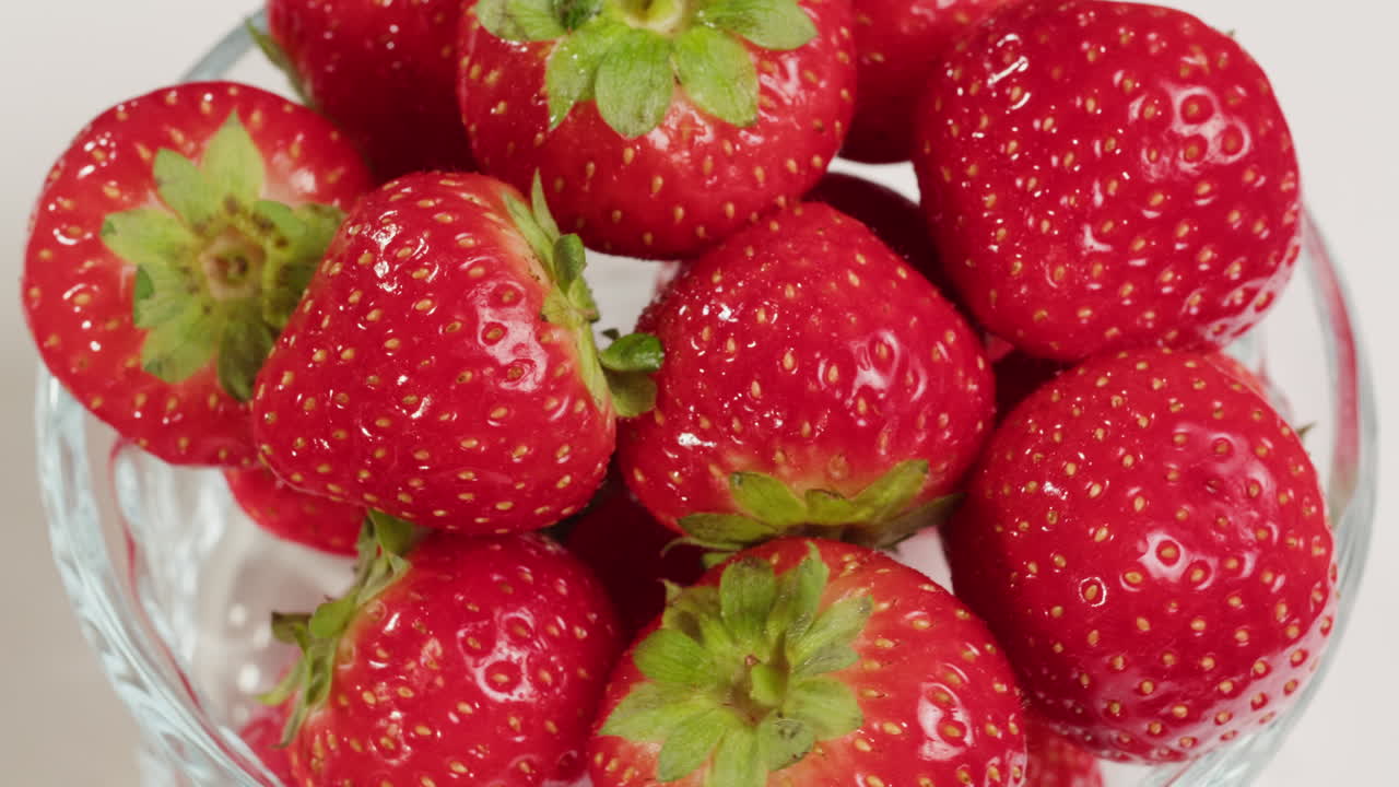 Fresh Red Strawberries Rotating in a Glass Bowl