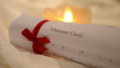 christmas carol music sheet with candles