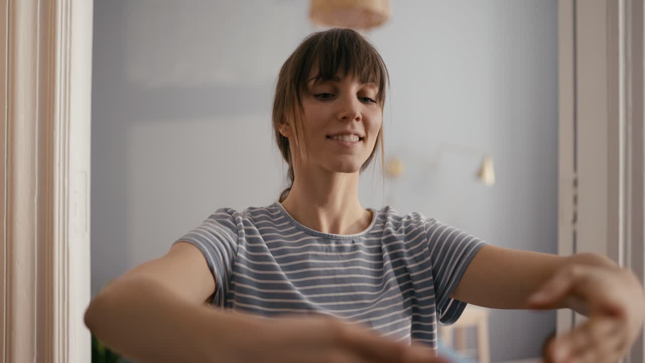 A woman dancing in her bedroom