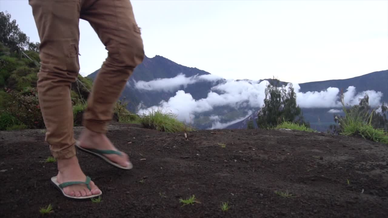 SLOW MOTION Feet Walking Across Edge Of Volcano Mountain, Mount Rinjani Indonesia
