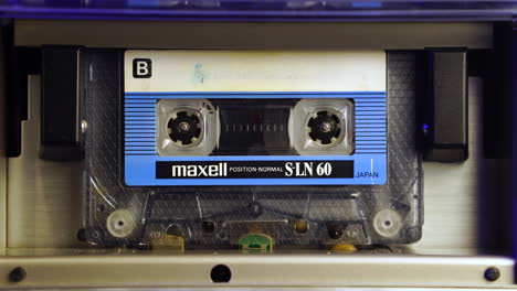 old audio cassette tape from 1980's spinning during playback, close up
