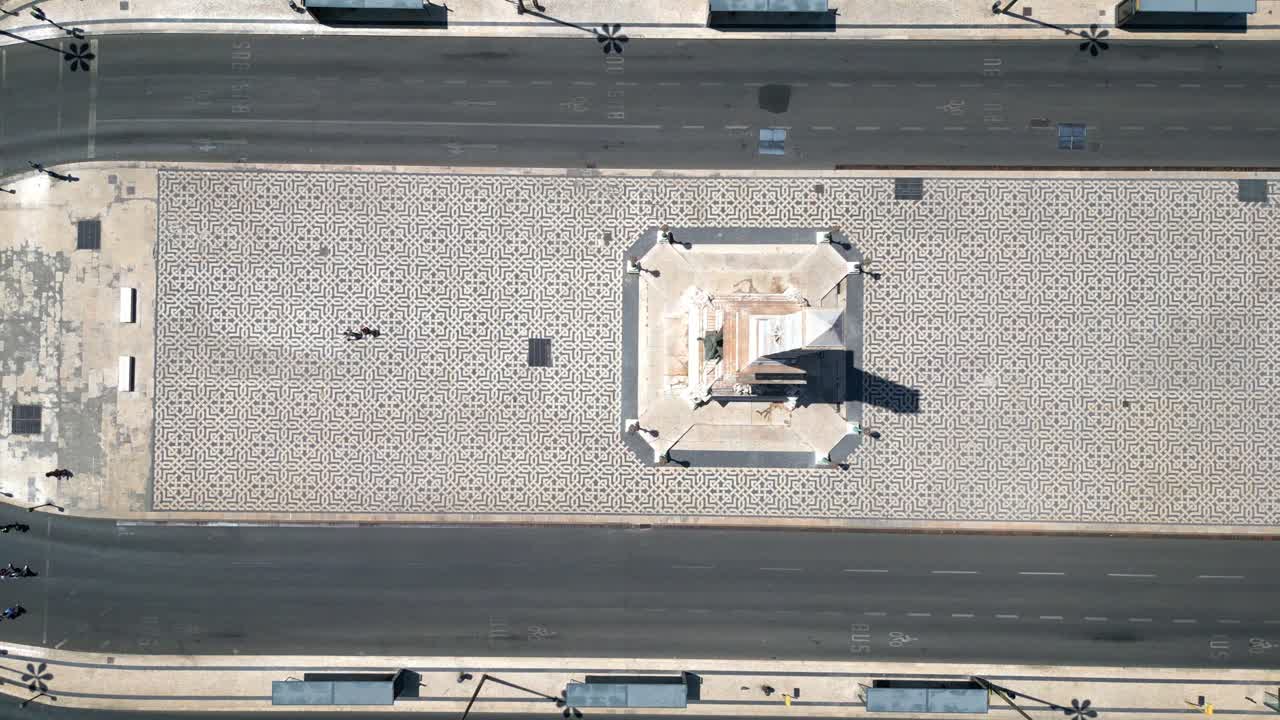 Aerial descending view over Restauradores Square with people walking on the beautiful portuguese sidewalk.lisbon,Portugal