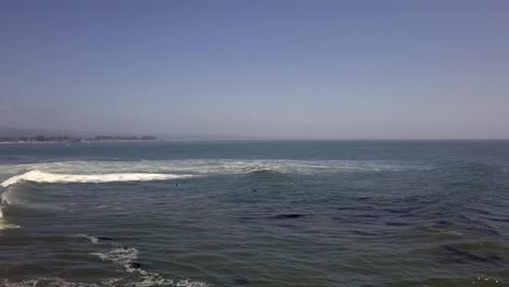 a lonely surfer all alone in the big dark scary blue ocean