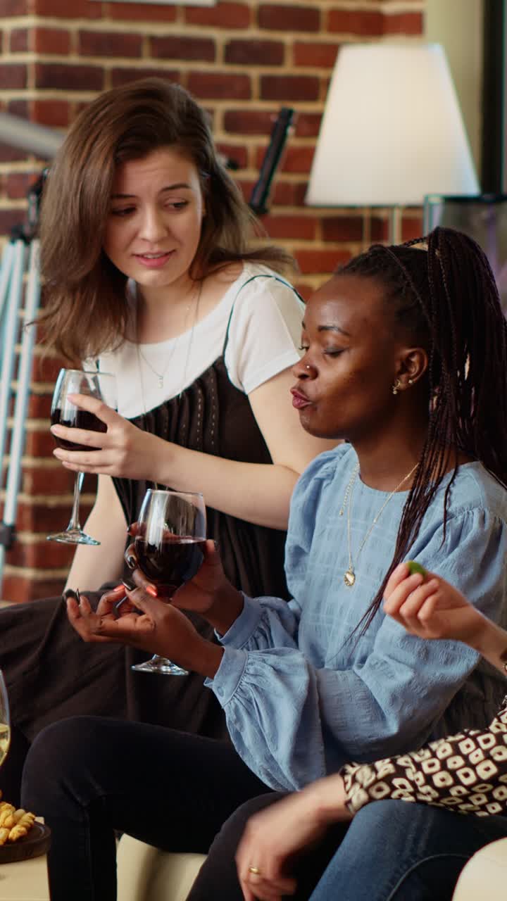 Vertical video Diverse group of people socializing at home, enjoying appetizers