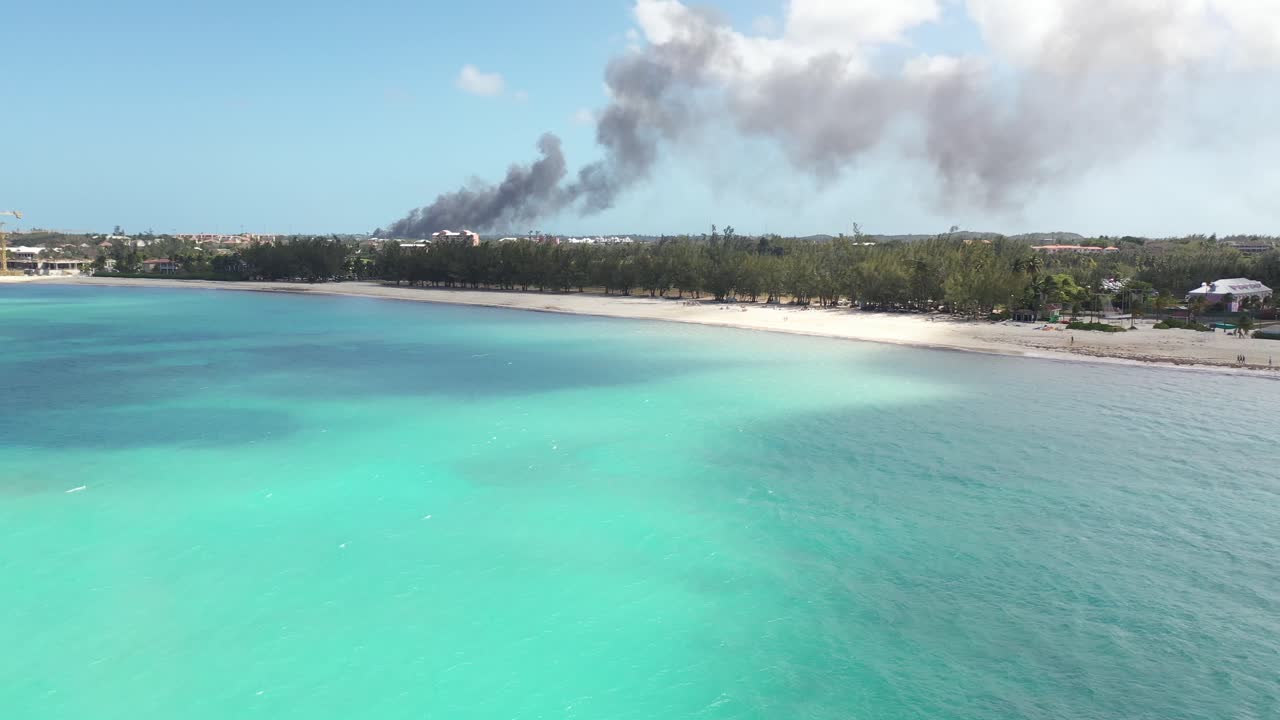 Aerial View of Fire Smoke Above Nassau, Bahamas, View of White Sand Beach and Blue Sea Water
