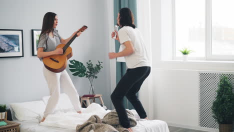 couple singing and dancing on bed