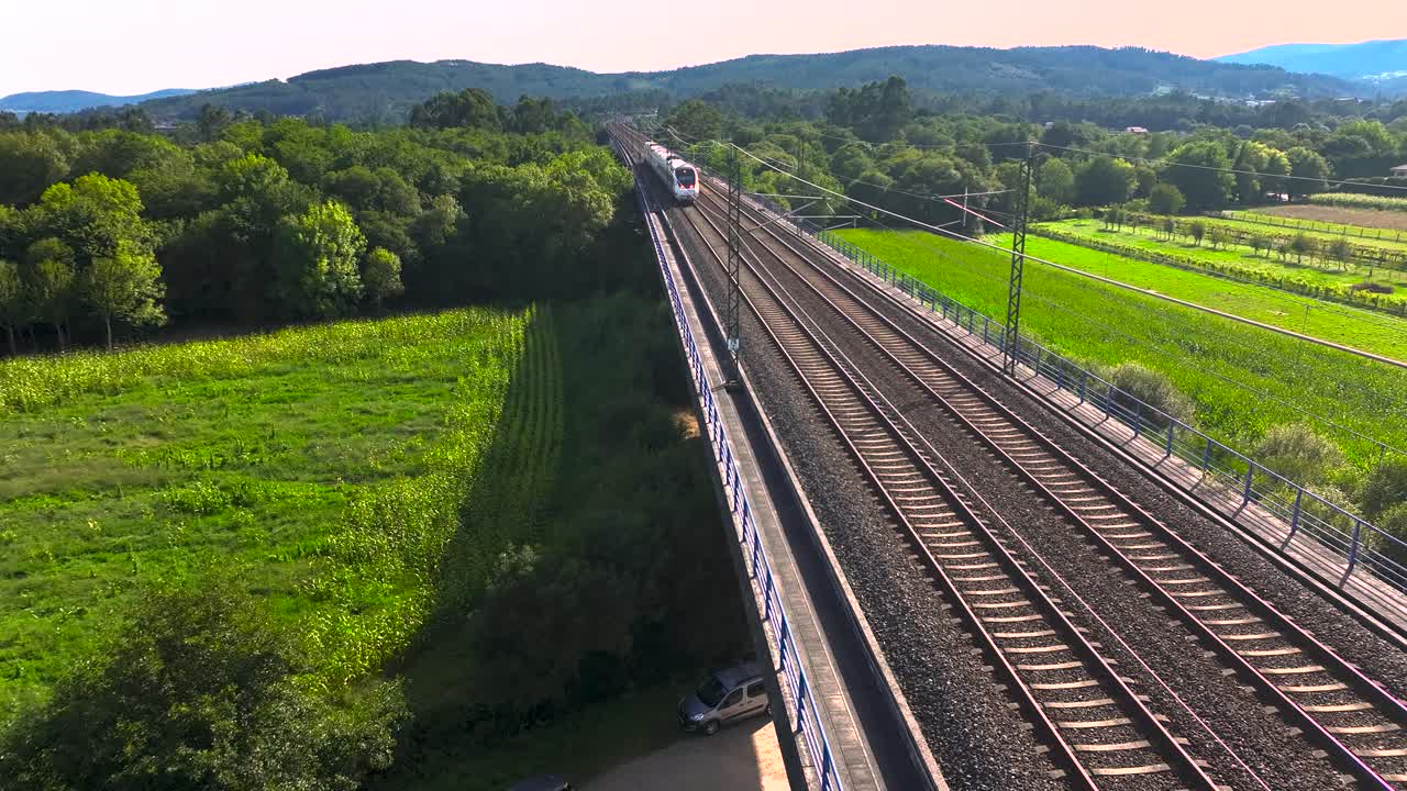 Railroad With Train Traveling On Tracks Over Green Rural Landscape In Padr&oacute;n, Rois A Coru&ntilde;a, Spain